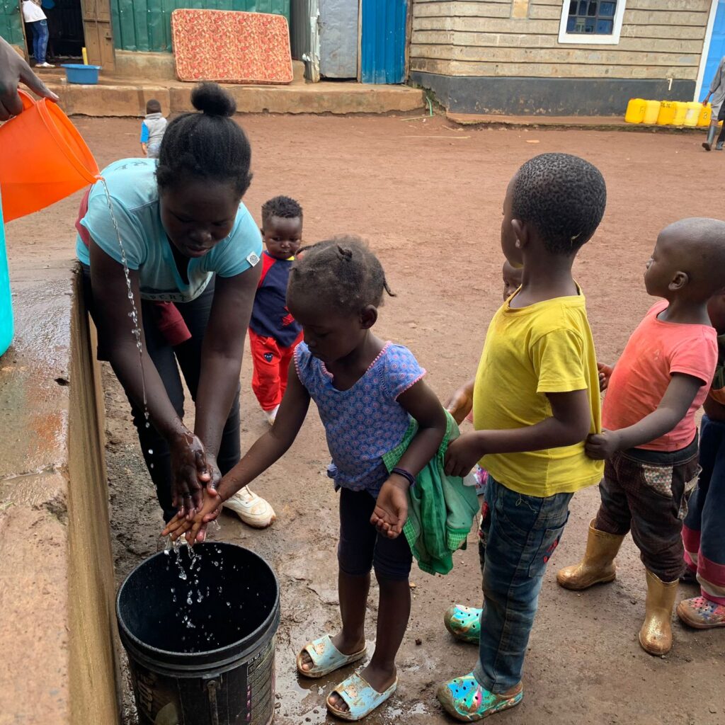 Children practising handwashing at a school water point