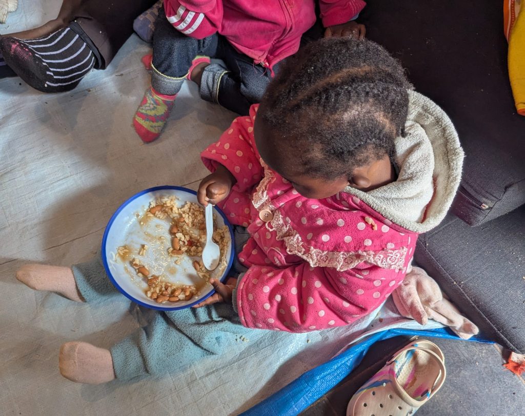 A young child eating a meal at the Centre