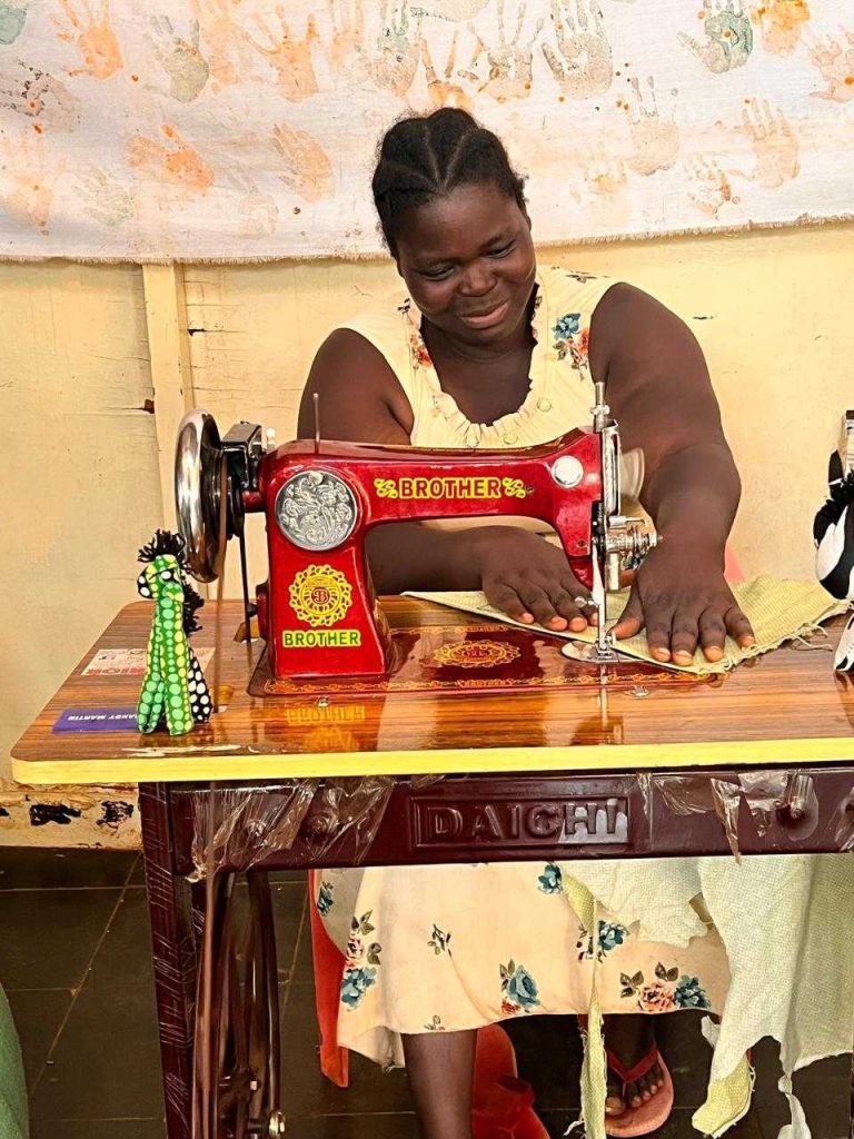A vocational training student at a sewing machine